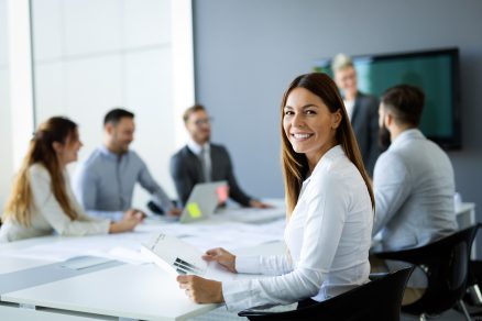 Woman Smiling During Work Meeting