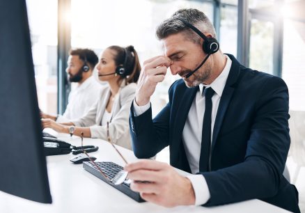 Man sitting at call center stressed out