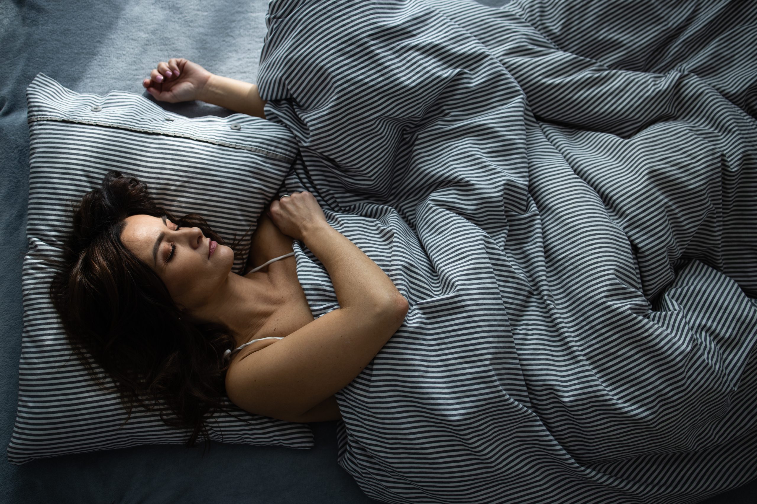 Pretty woman sleeping on her bed